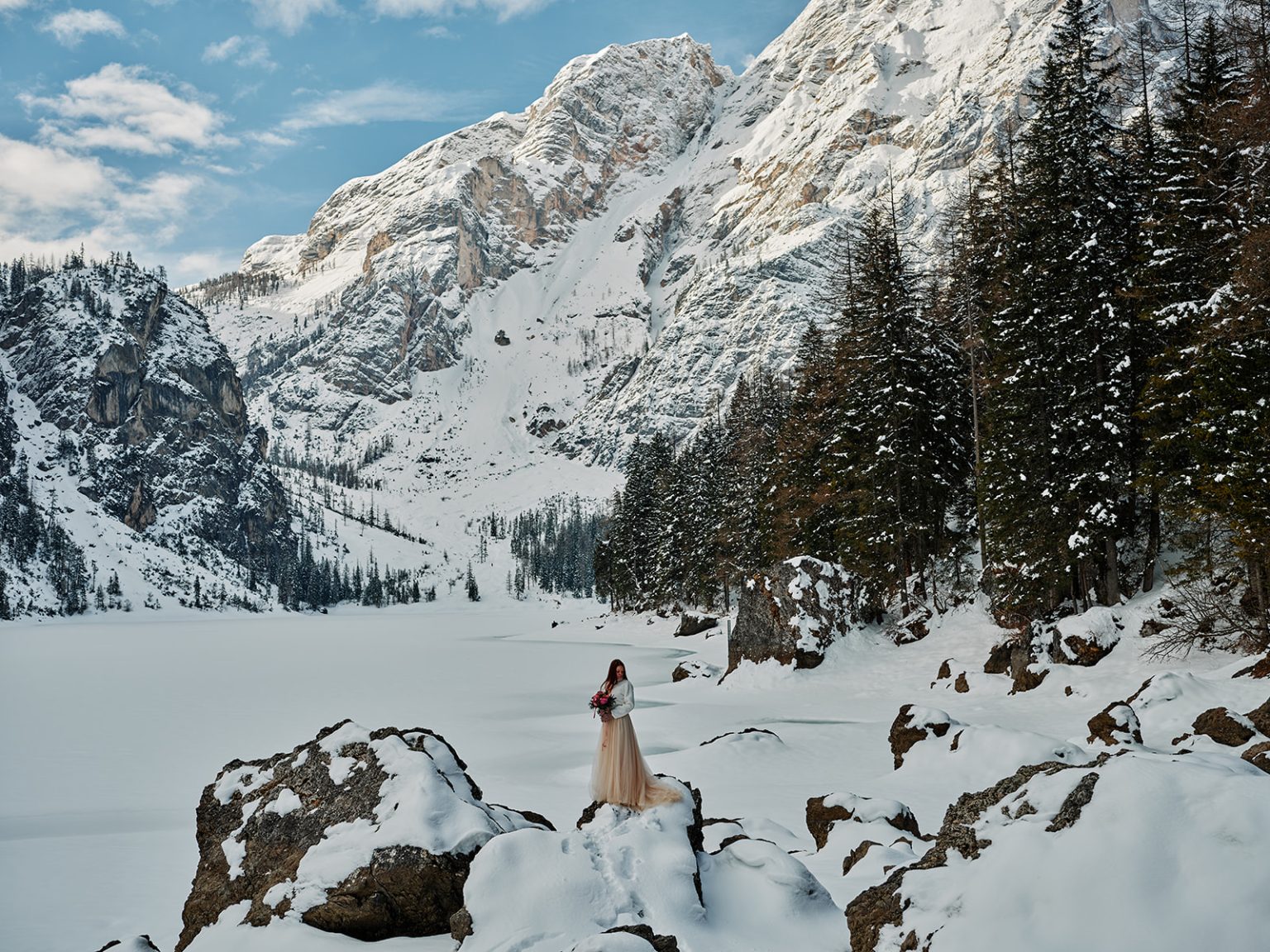 Kristina and Cristian on the snowy rocks at Braies, Dolomites, Italy