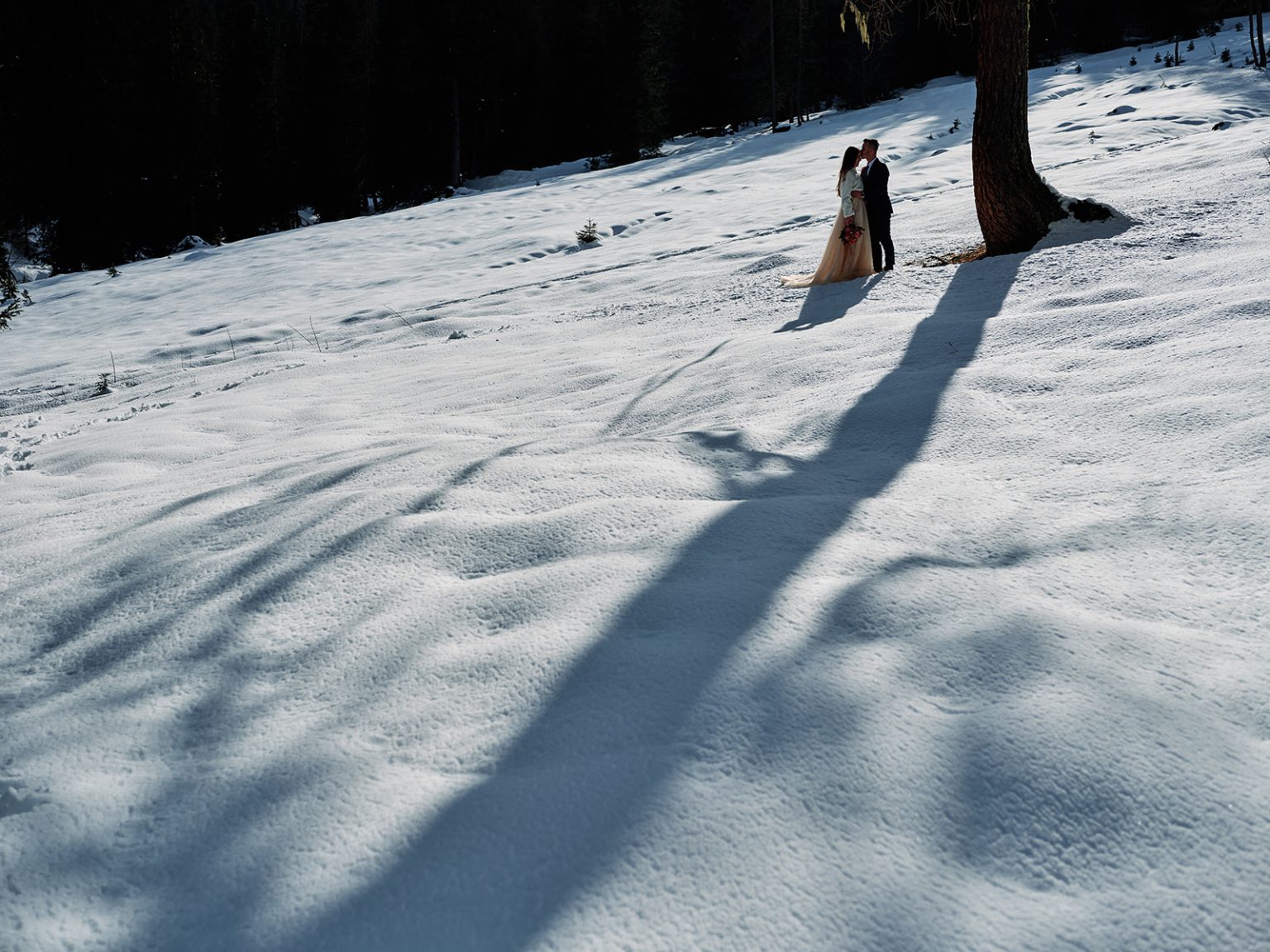Long winter shadows across the snow at Passo Giau, Dolomites winter elopement
