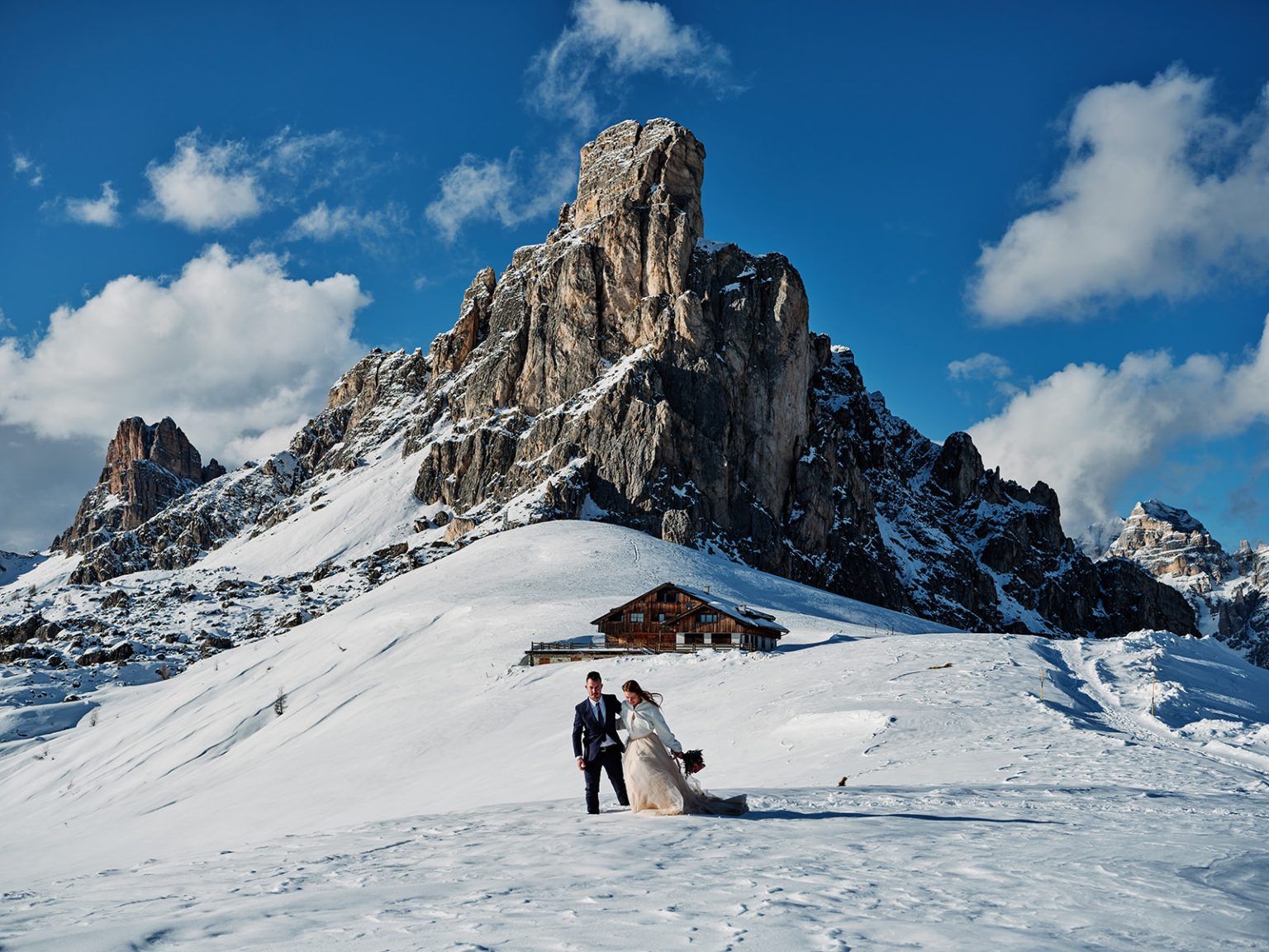 Kristina and Cristian below the peak at Passo Giau, a winter elopement in Italy