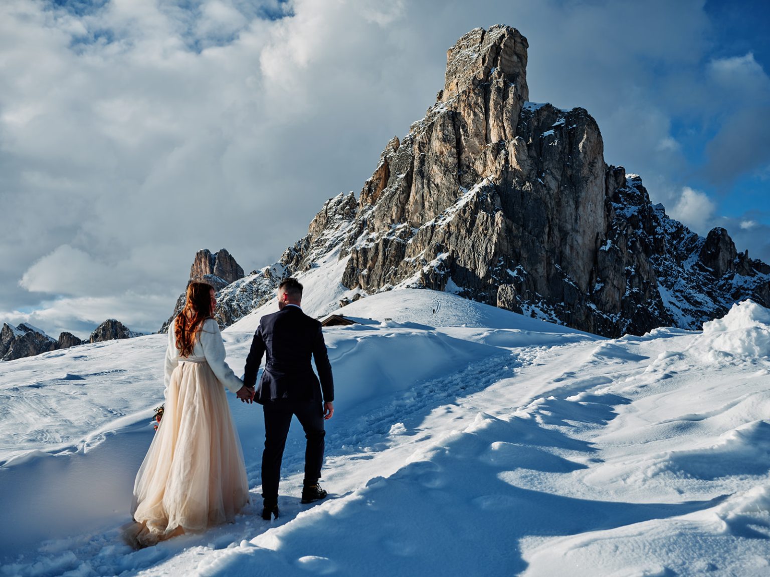 Walking toward the peak at Passo Giau, a Dolomites winter elopement