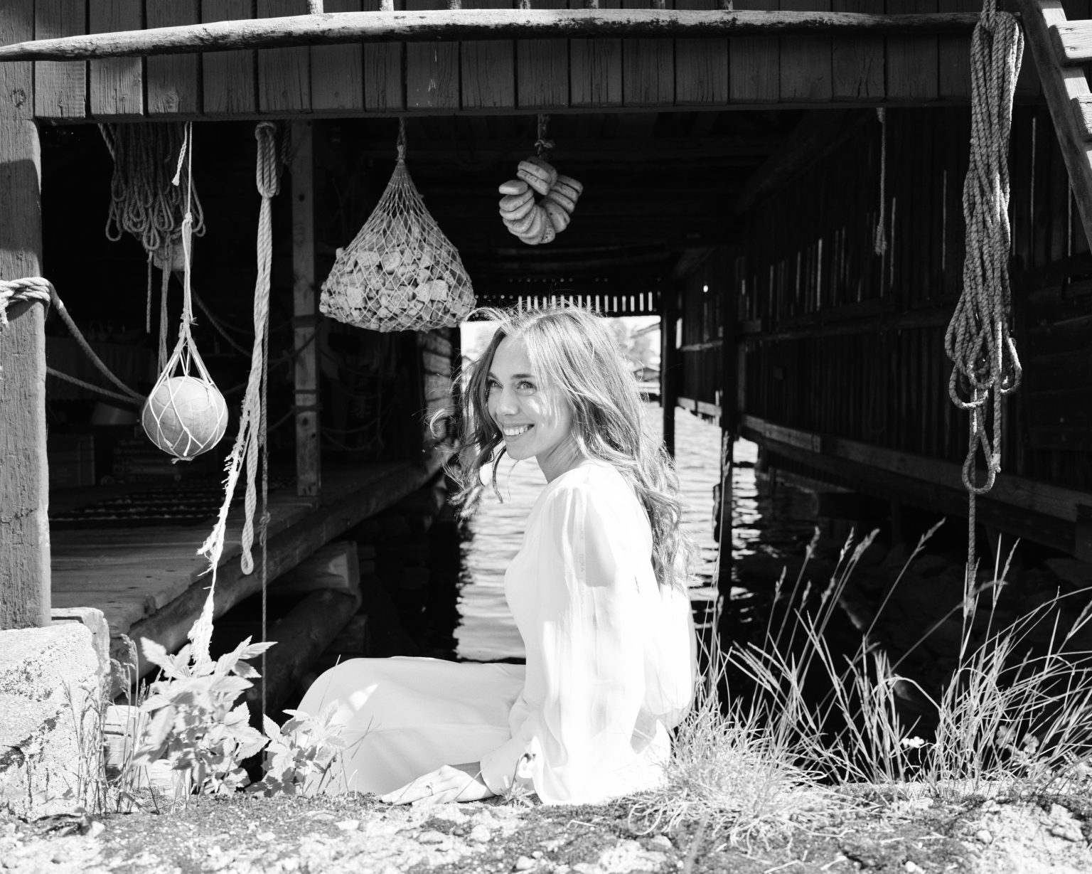 Bride among the hanging net floats at Skärså fishing harbour