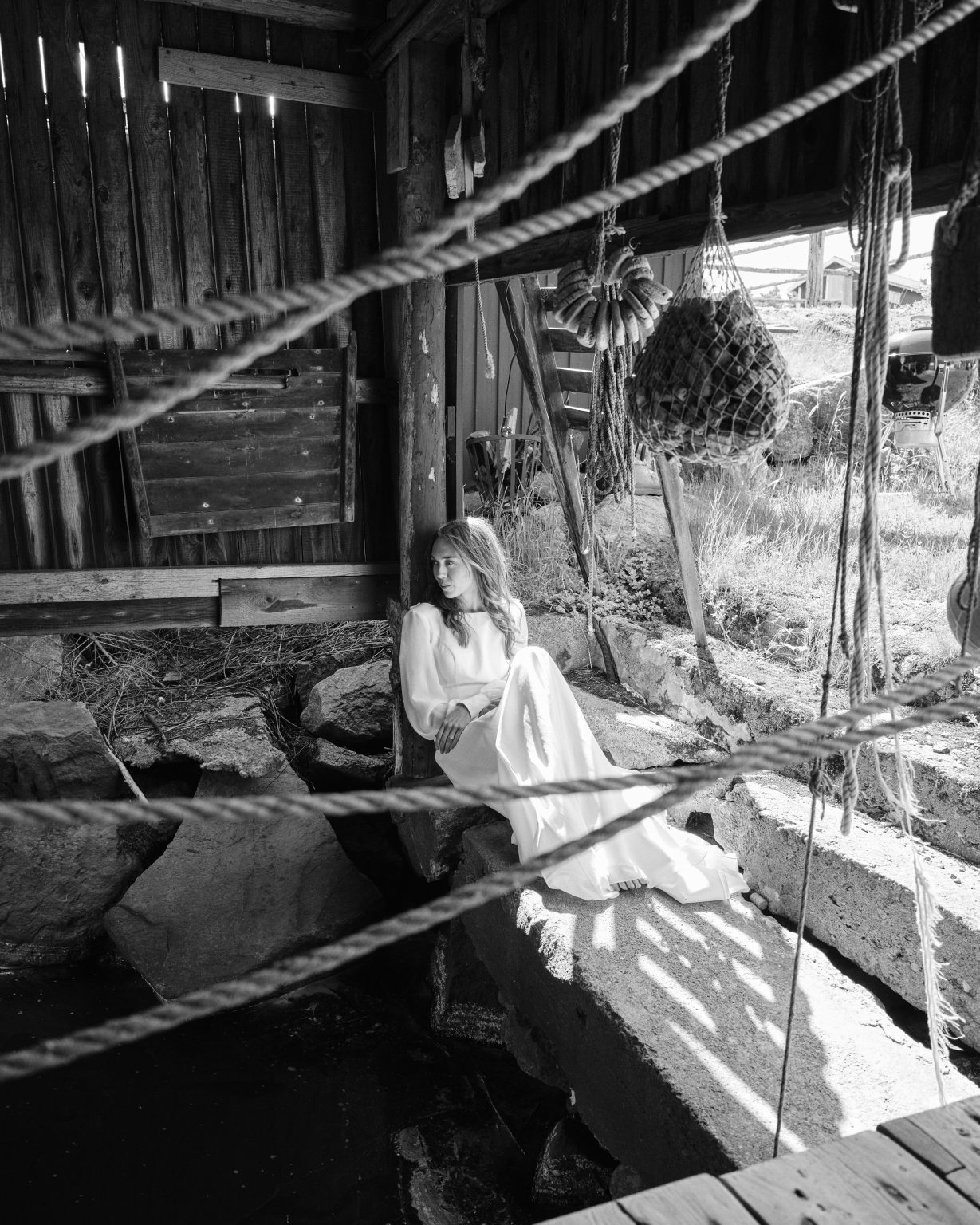 Bride inside an old boathouse at Skärså, ropes and rigging around her