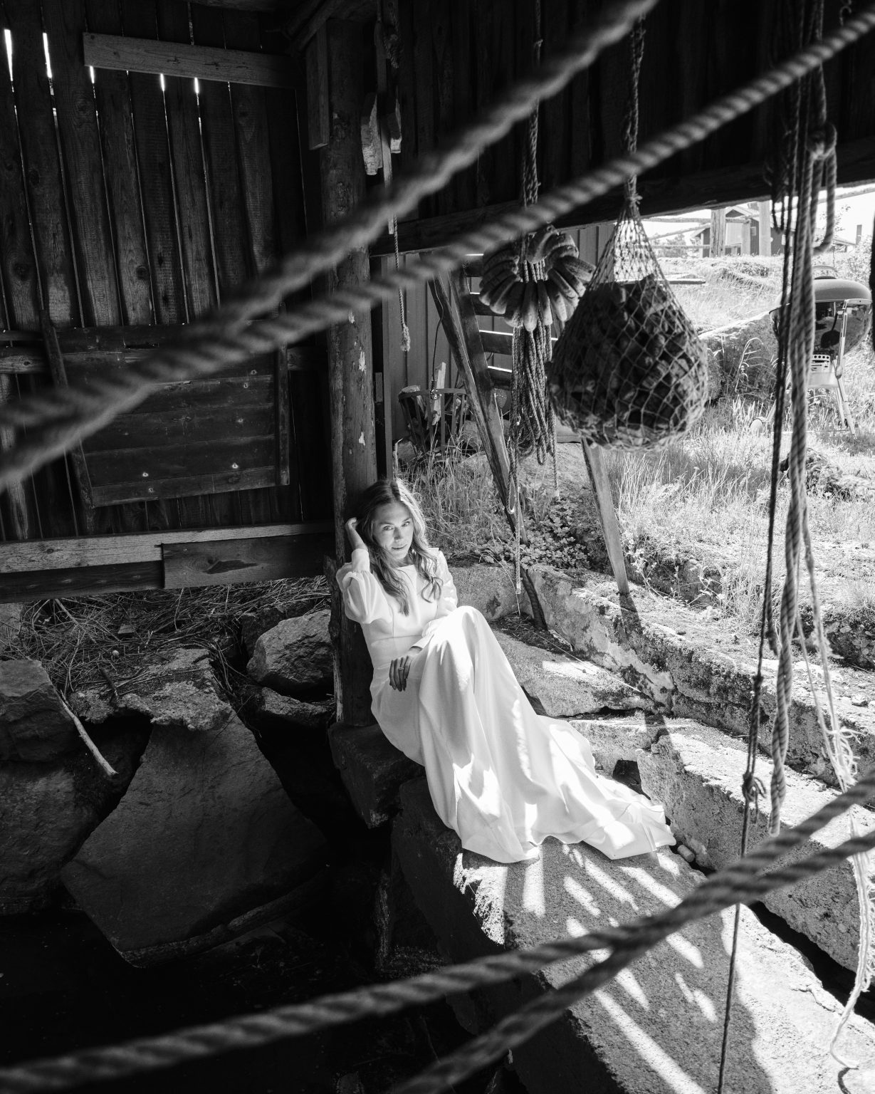 Elin seated in a Skärså boathouse on the Baltic coast