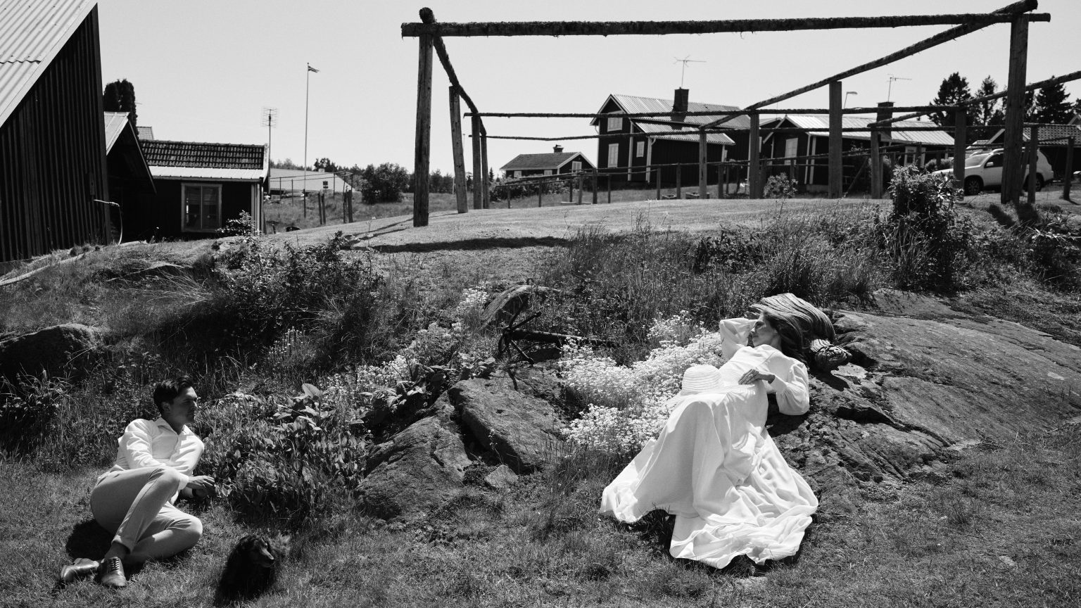 Bride on the rocks by the red sheds of Skärså harbour