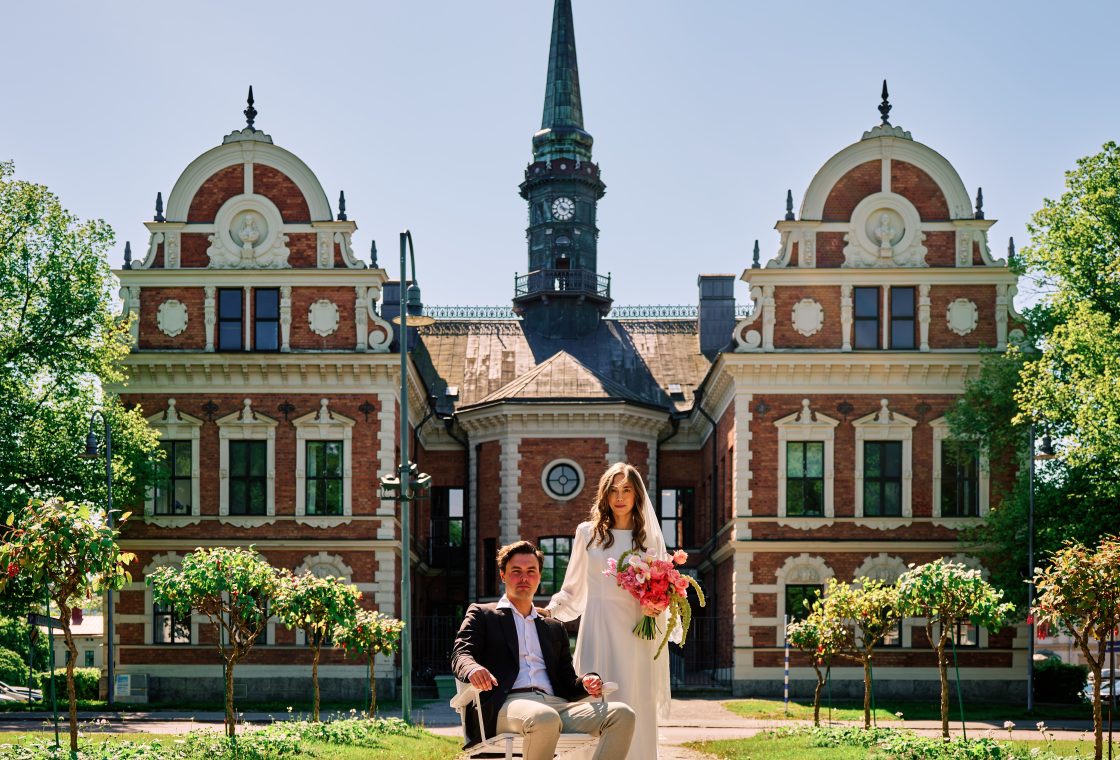 Elin and Joakim in front of the green-spired landmark in Söderhamn, Sweden