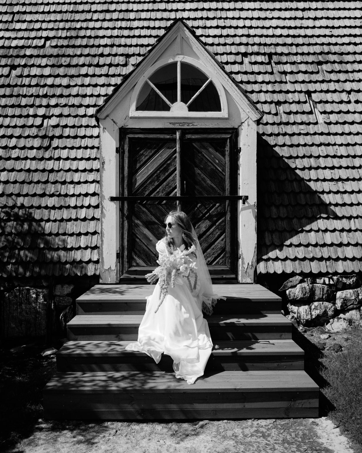 Bride on the steps of a wooden chapel in Söderhamn
