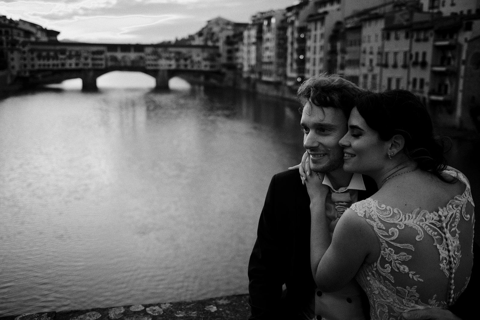 Bride and groom close together with the Ponte Vecchio behind