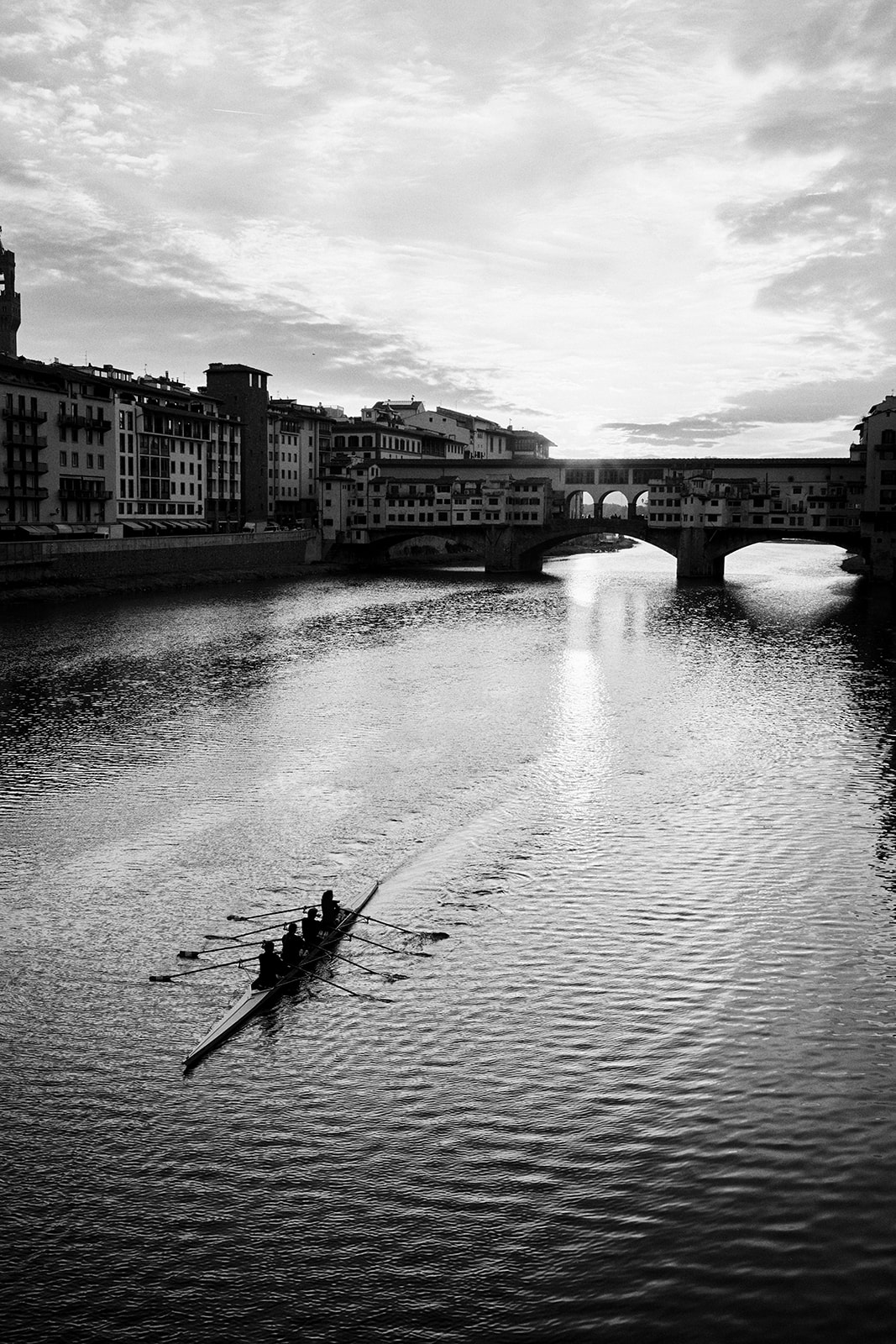 Couple by the Arno as the sun rises over Florence