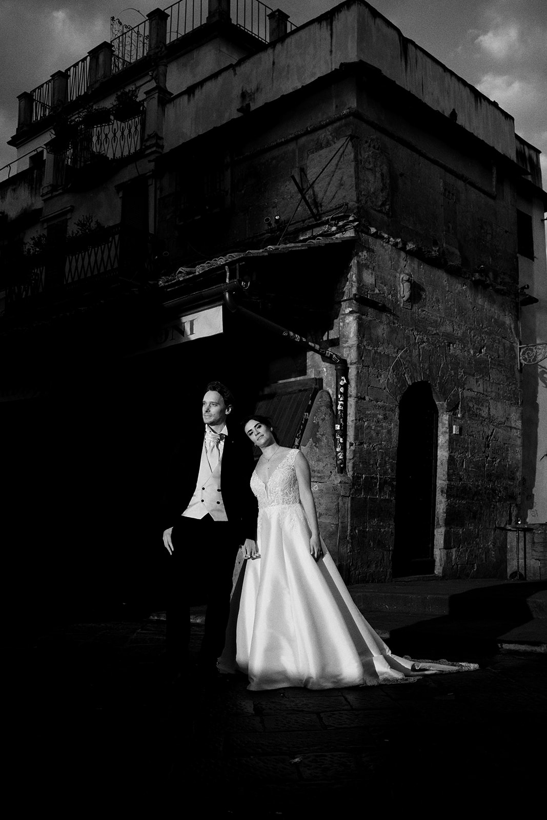 Bride's dress swinging in a Florence portico at dawn