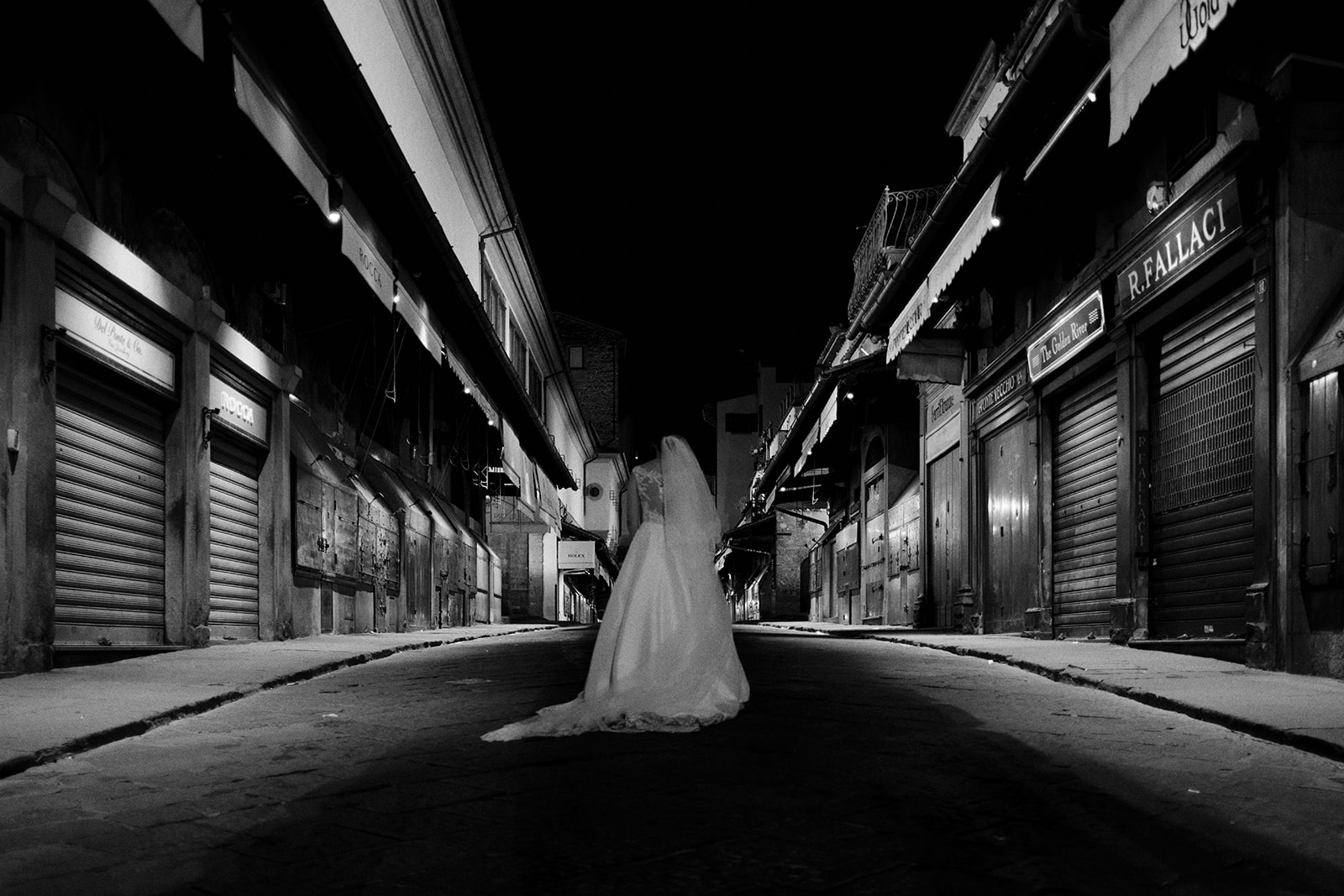 Bride walking an empty Florence street at first light