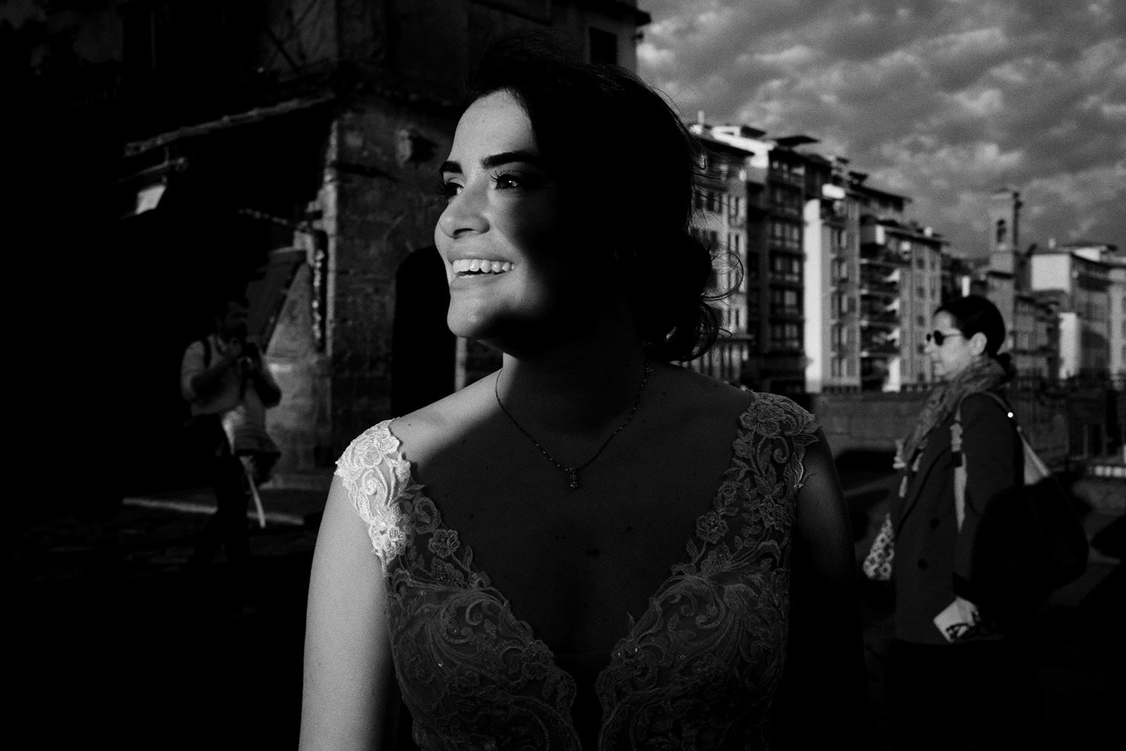 Bride smiling with Florence behind her at sunrise