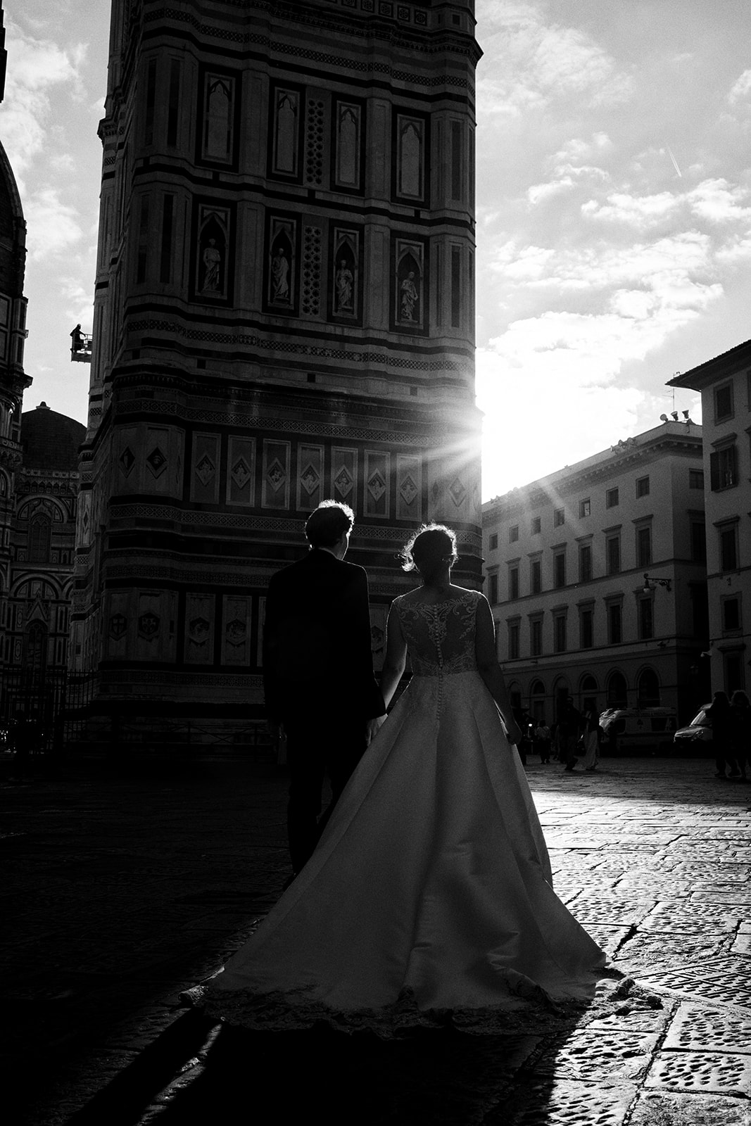 Silhouette of a couple in a Florence piazza against the rising sun