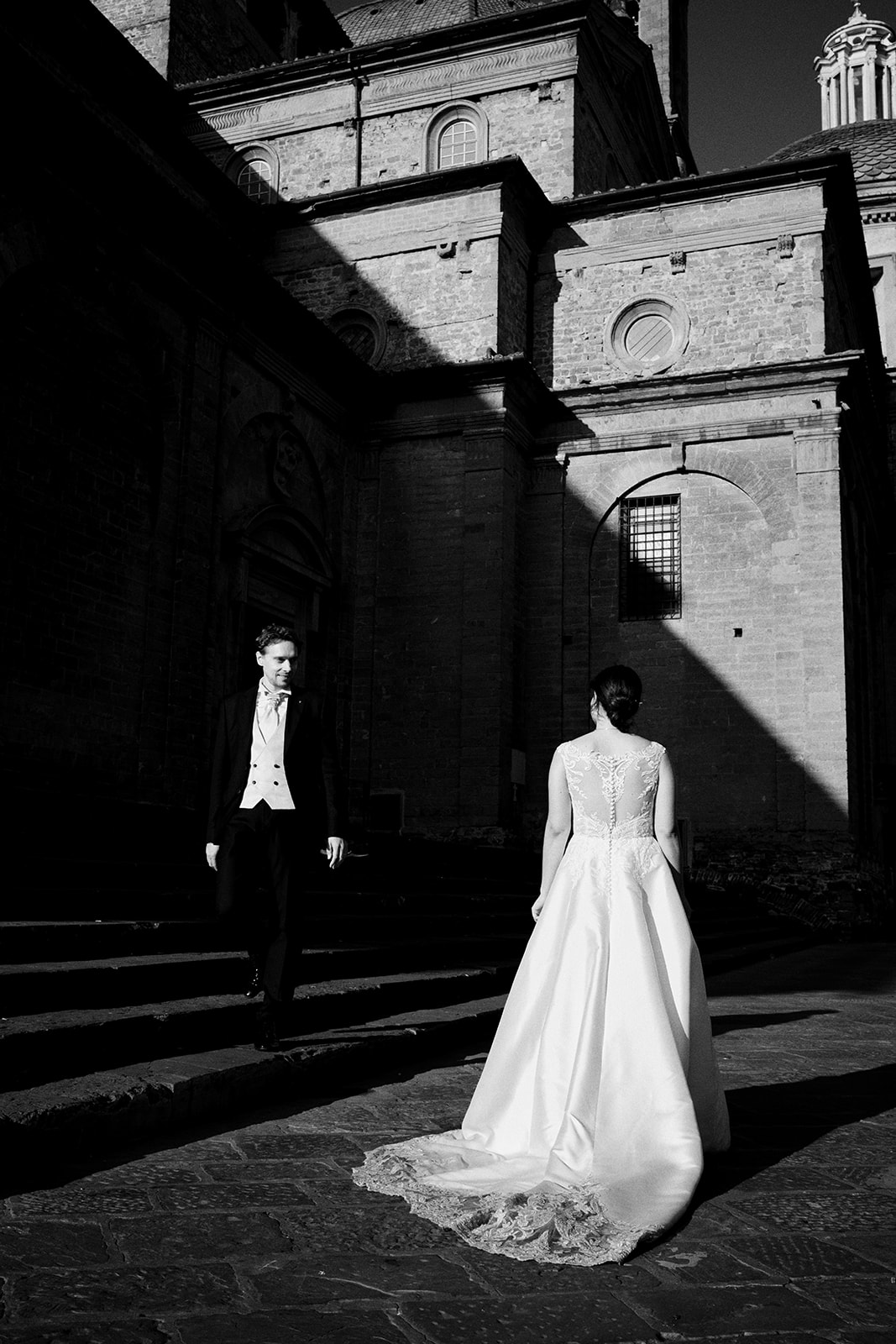 Bride and groom before a Florence church at sunrise