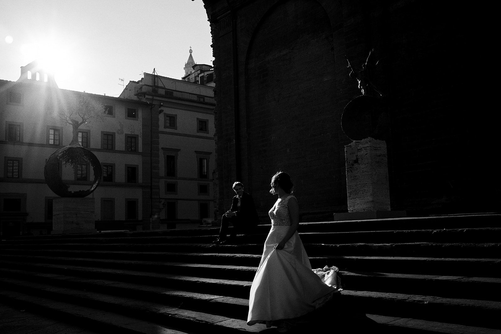 Couple on the steps against the rising sun in Florence