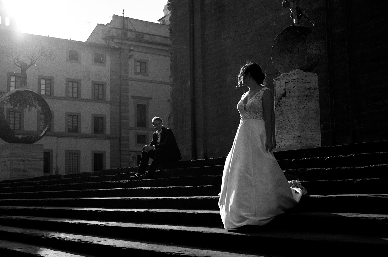 Bride climbing sunlit steps in Florence at the end of the session