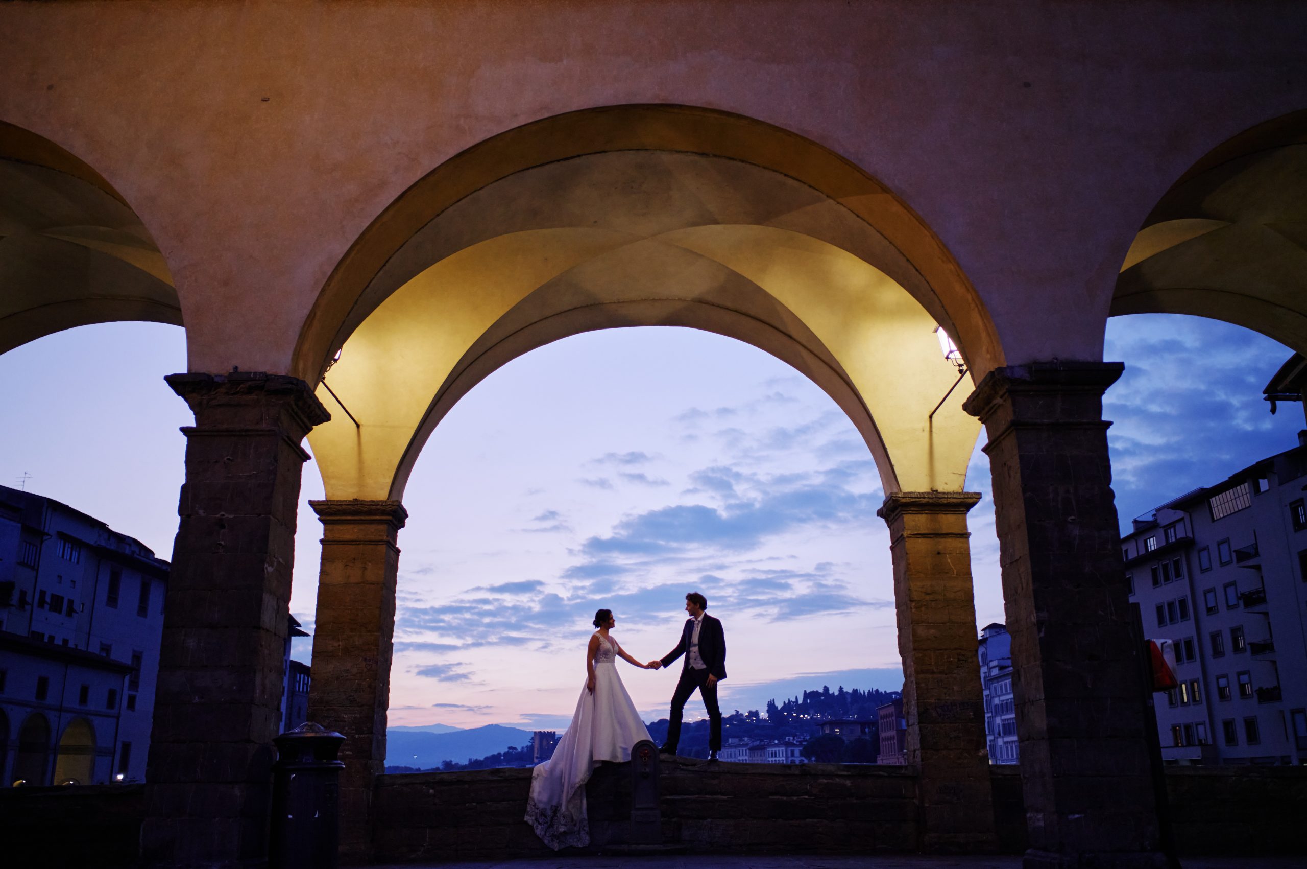 Federica and Marco framed in an archway as dawn breaks over Florence, the only colour photograph in the set