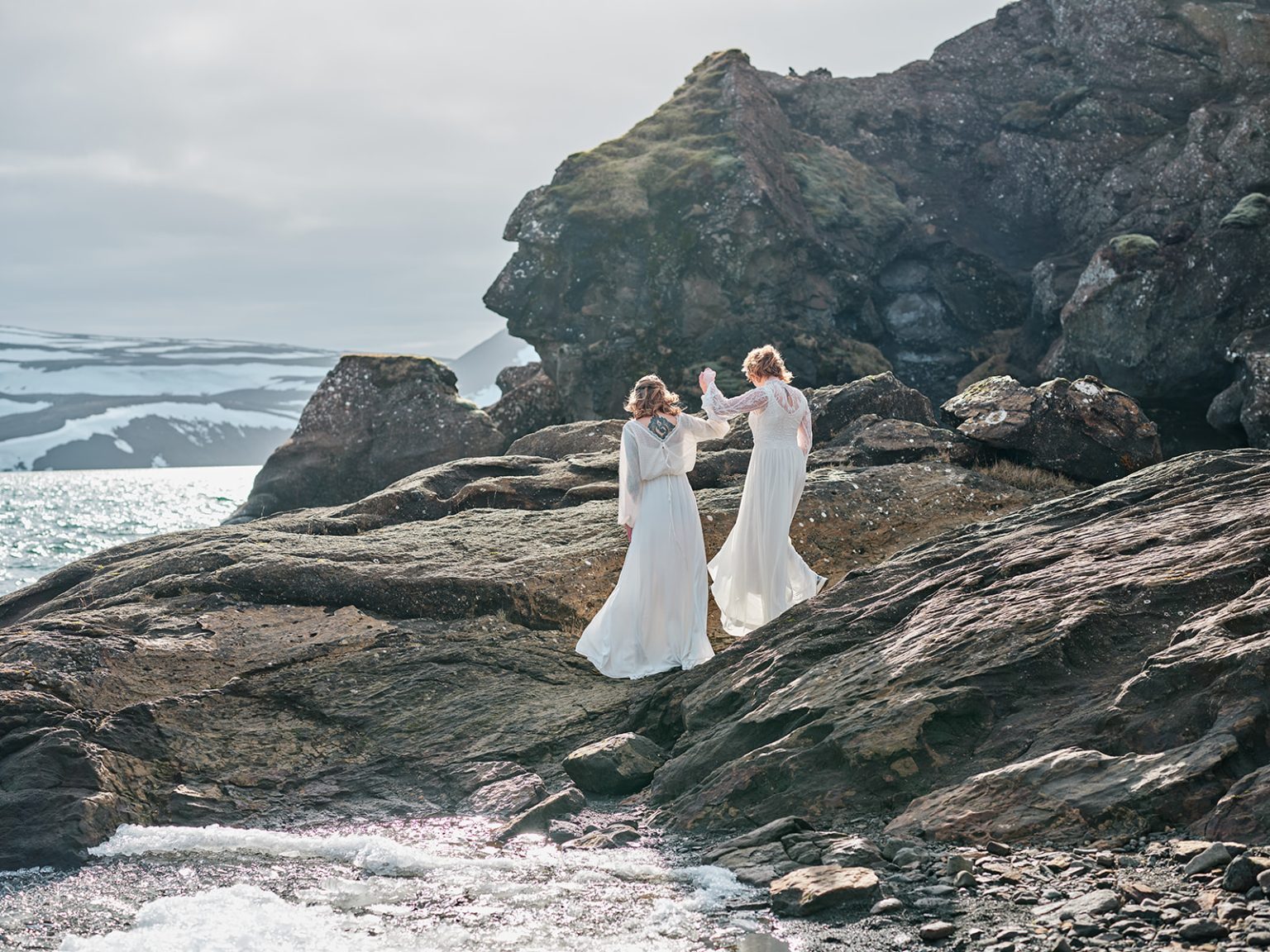 Two brides walking the lava coast, a gay elopement in Iceland