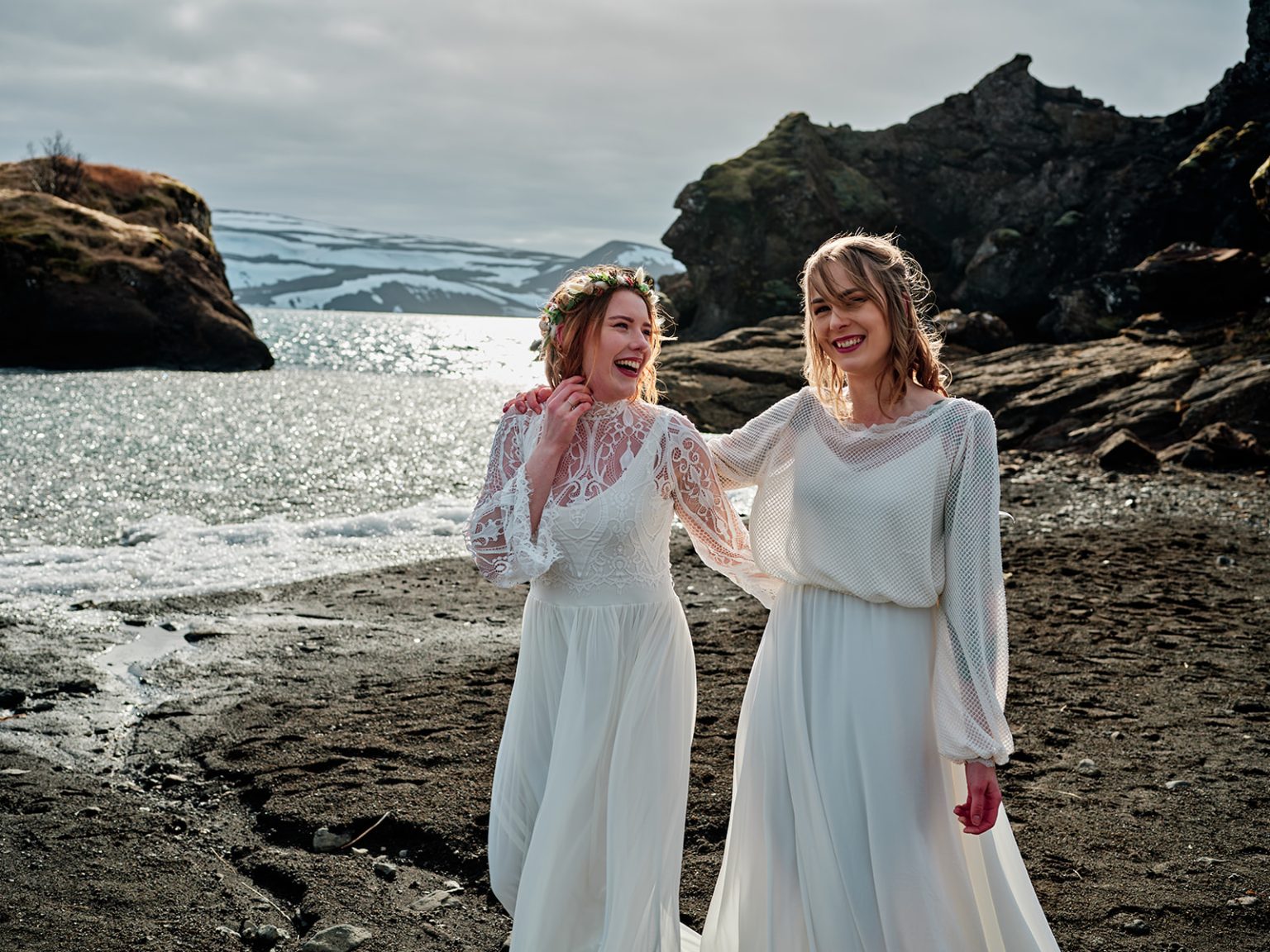 Glóþór and Sólveig close together on the rust-red rock, Reykjanes