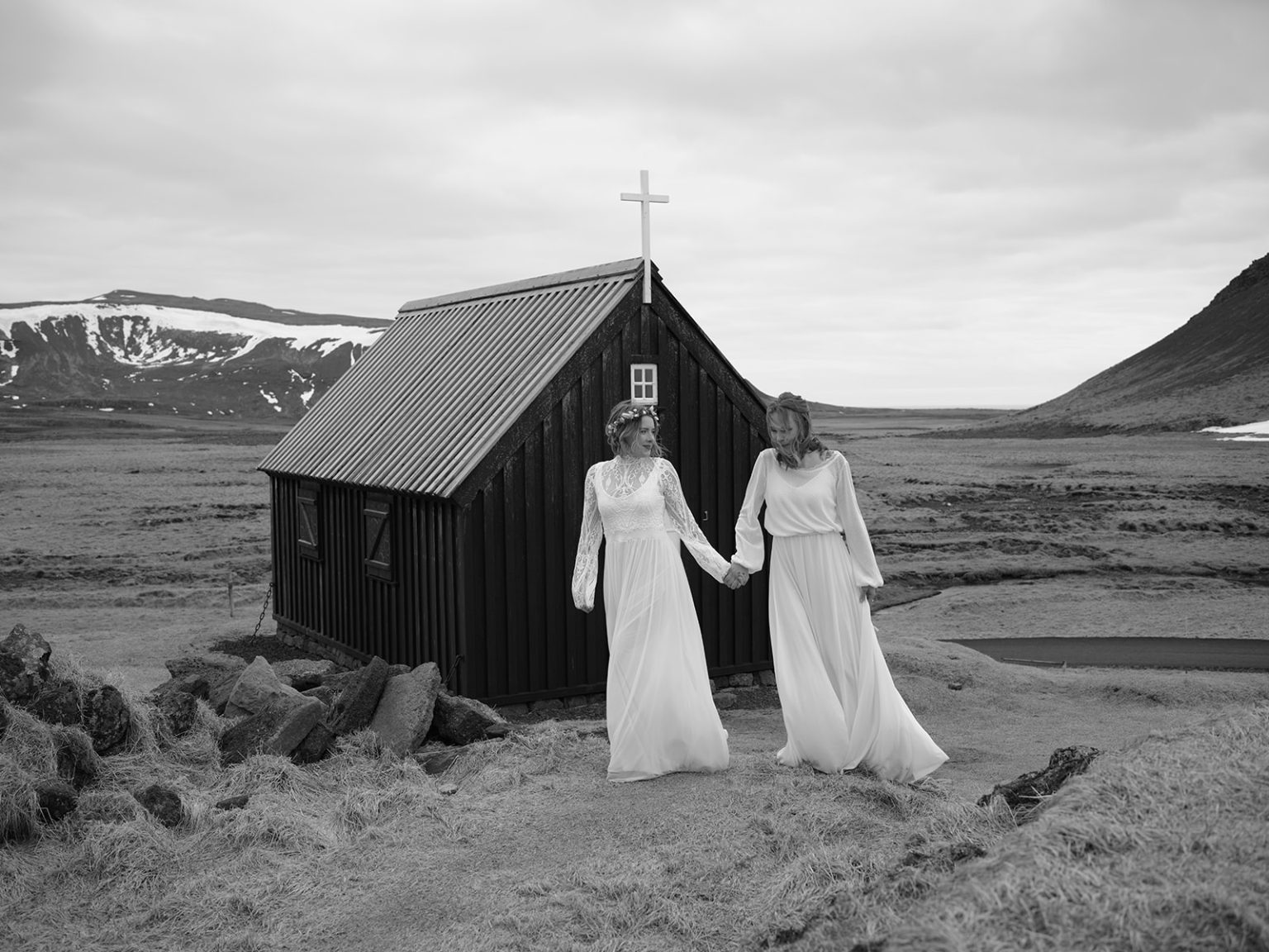 Two brides at a small black church in Iceland, in black and white