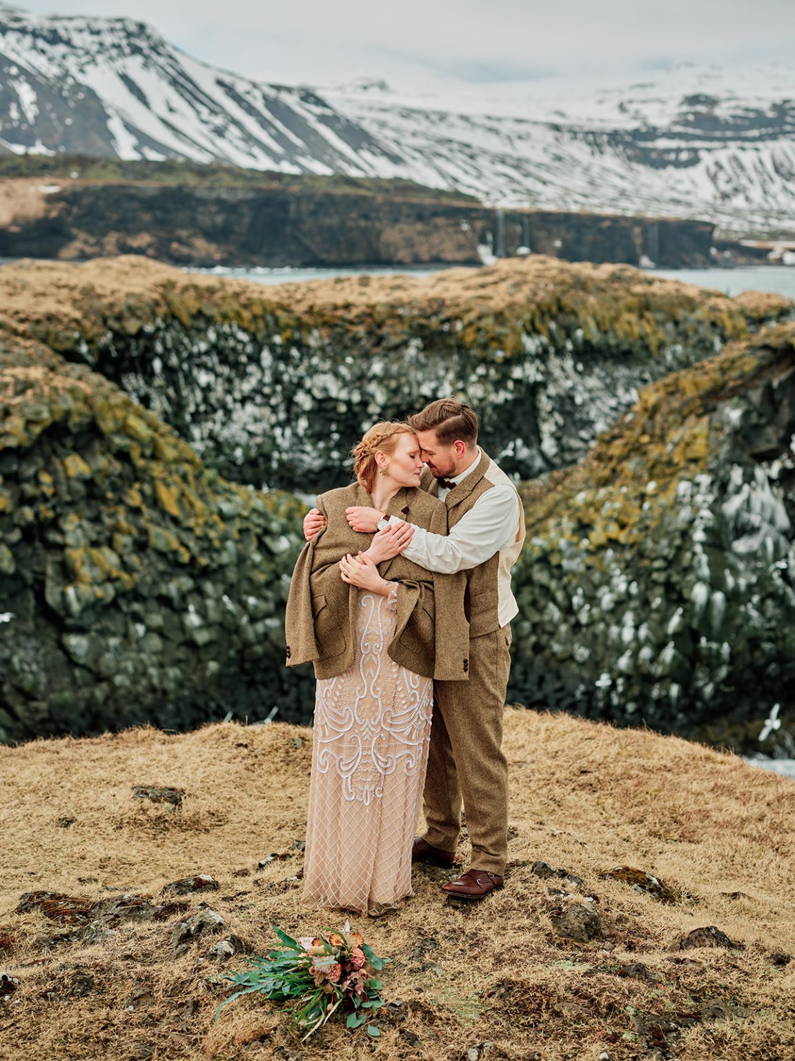 Halldóra and Örn embracing by the Arnarstapi arch, Snæfellsnes