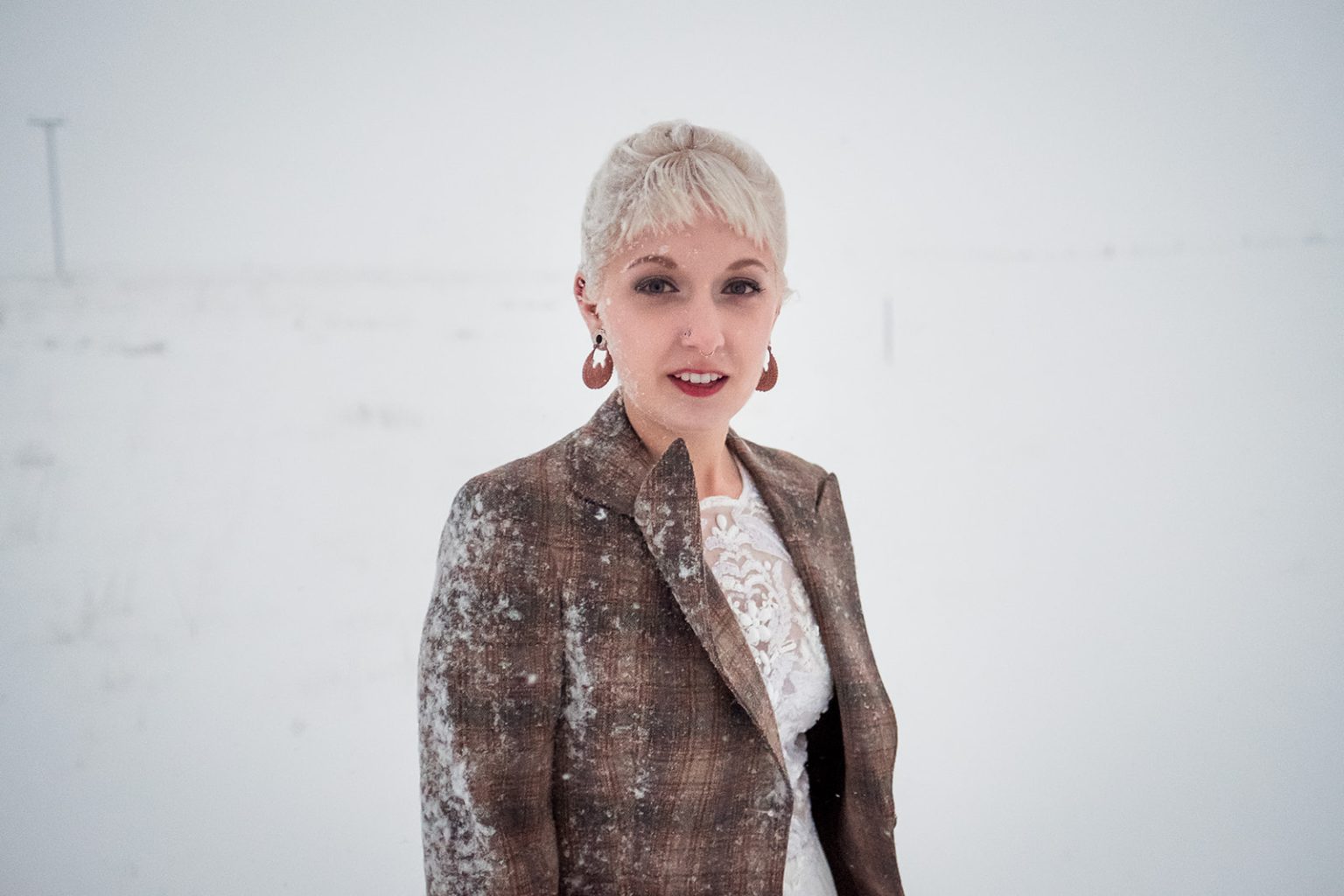 Winter bride portrait in the snow in Hvalfjörður, Iceland