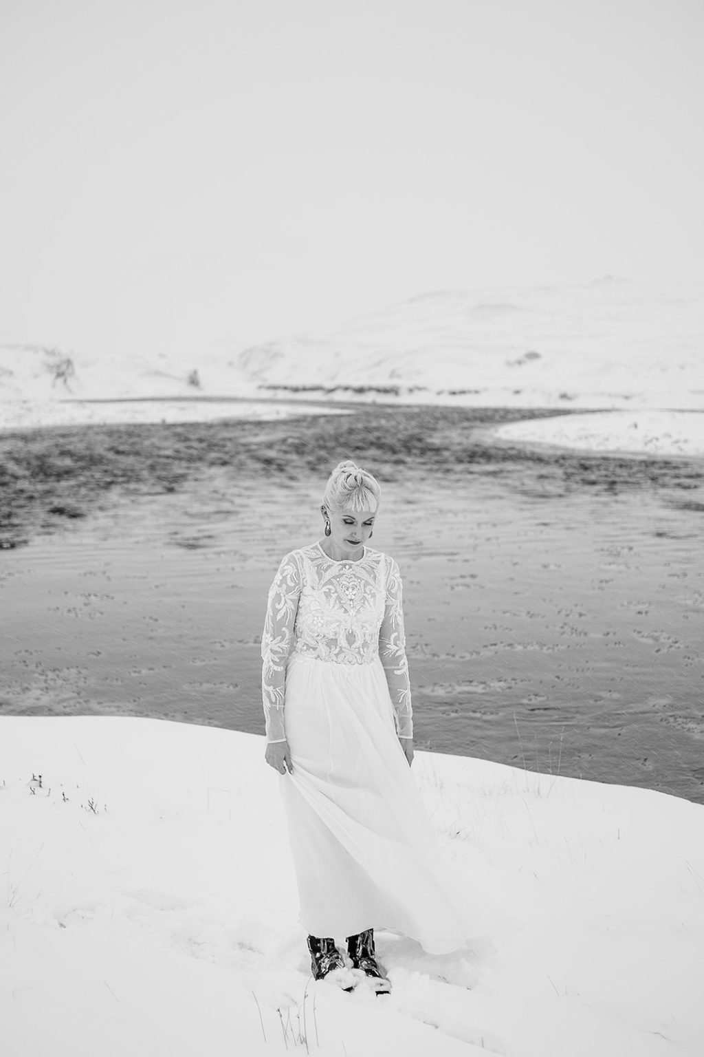 Winter bride portrait on a snow-covered riverbank in Iceland