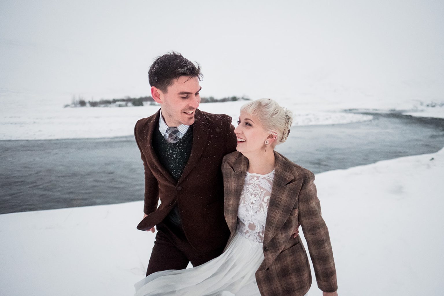 Bride and groom together in the snow on their winter wedding day