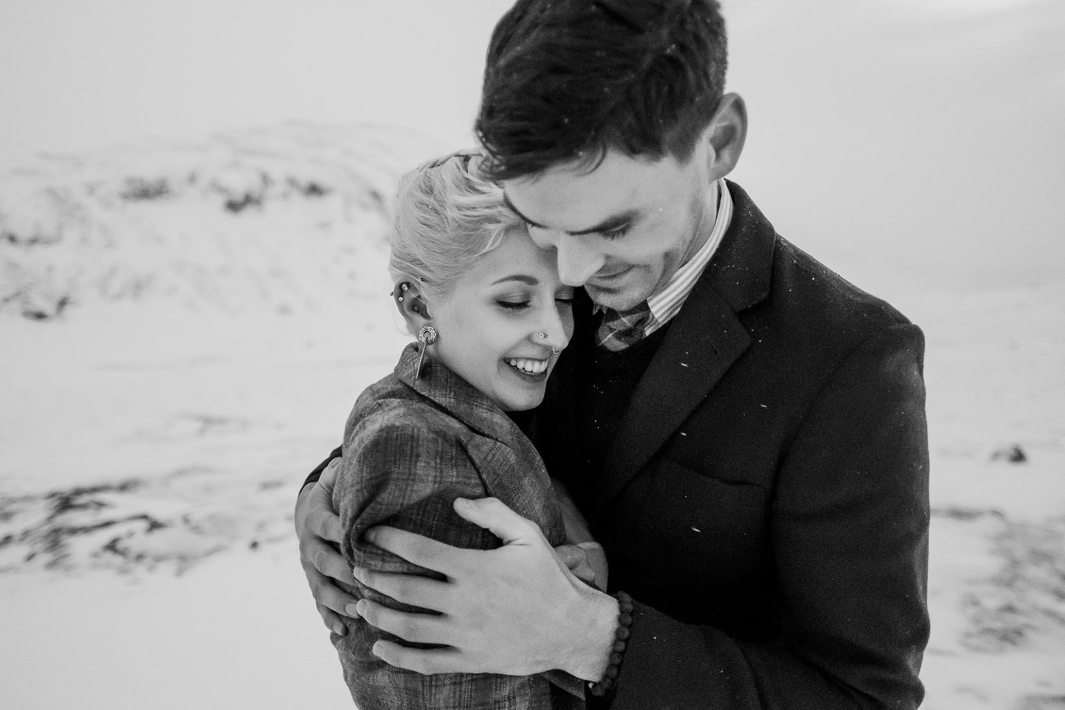 Close black and white portrait of the couple in the Icelandic cold
