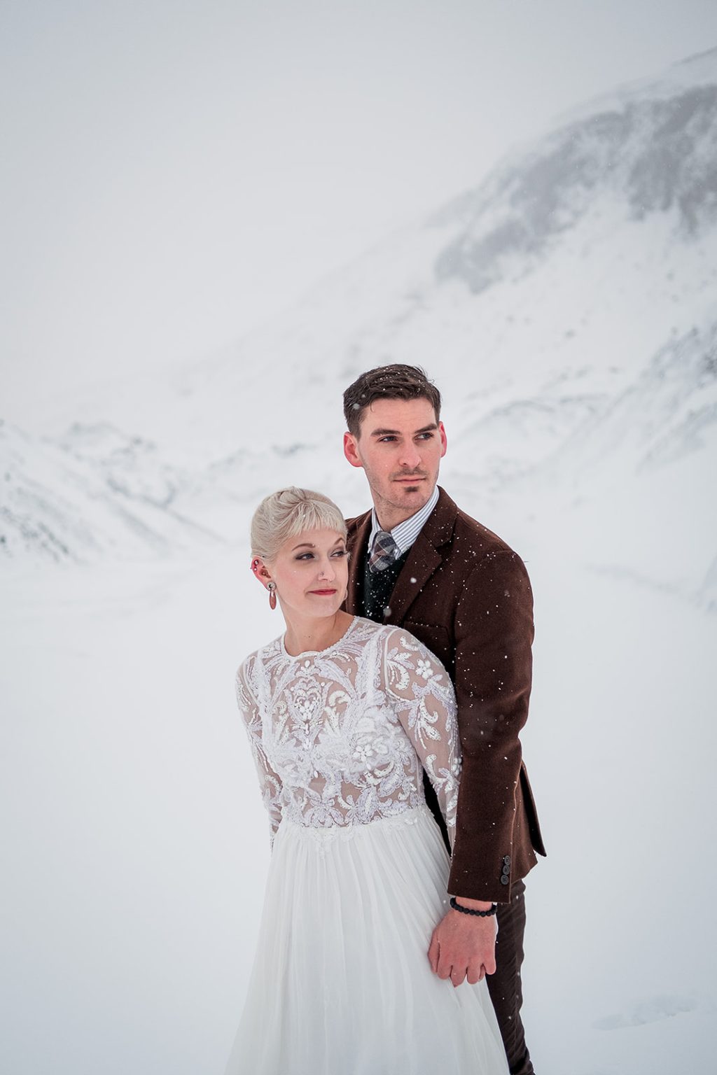 Bride and groom together in the snow in Iceland