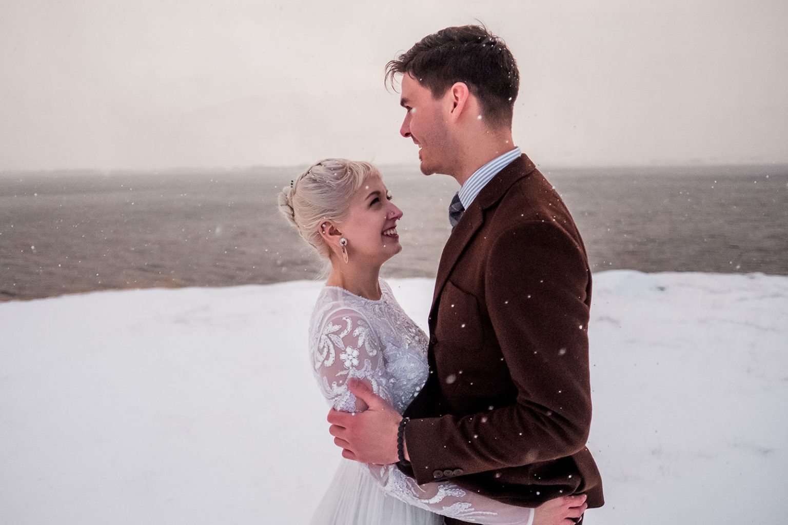 Bride and groom by the sea in Hvalfjörður