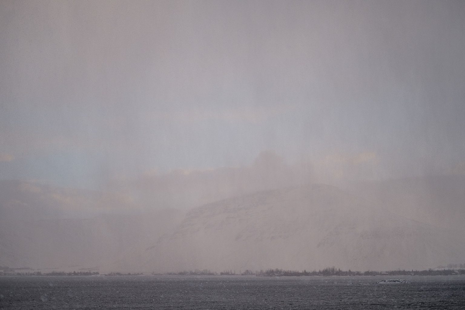 Couple embracing by the winter sea in Iceland