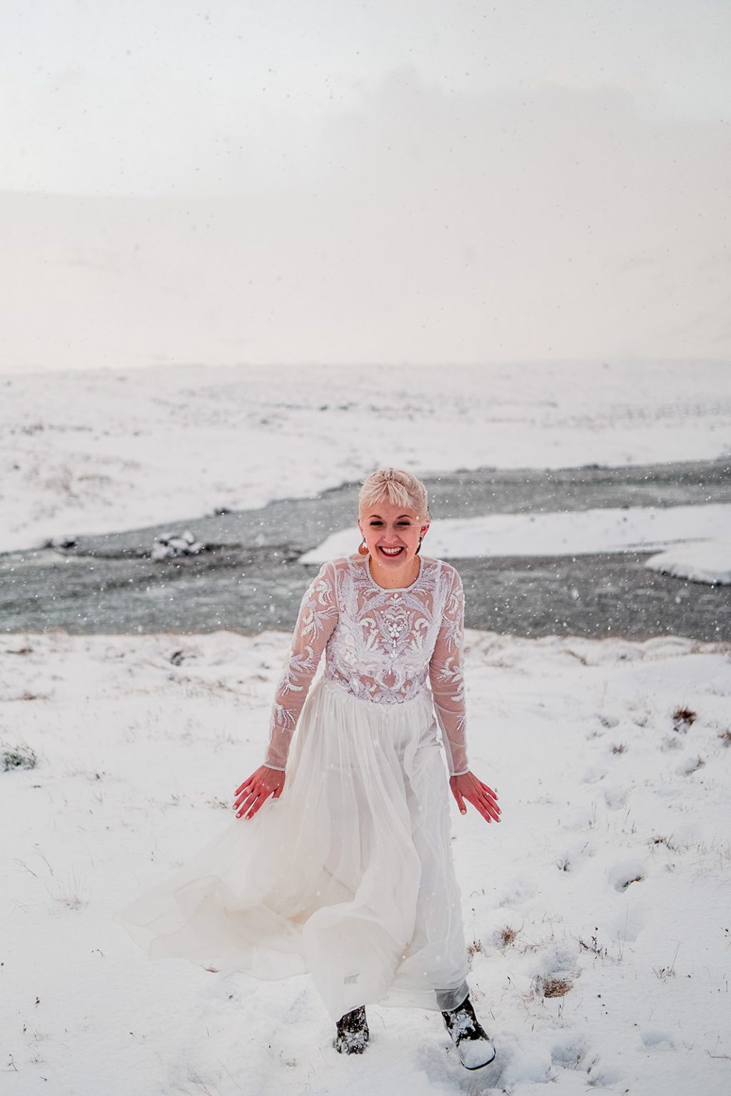 Bride by the sea on her winter wedding day
