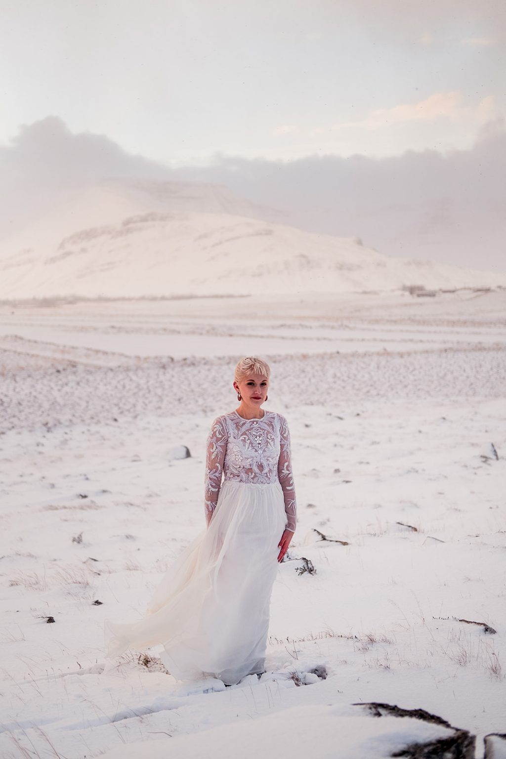 Bride on the shoreline in Hvalfjörður, Iceland