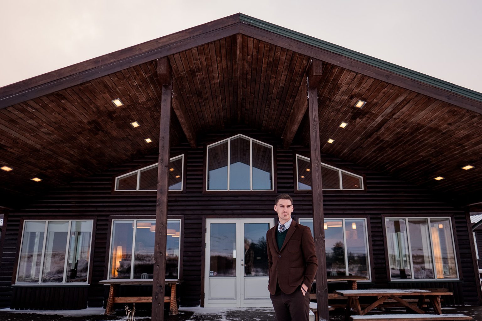 Groom outside the wedding venue in the snow in Hvalfjörður