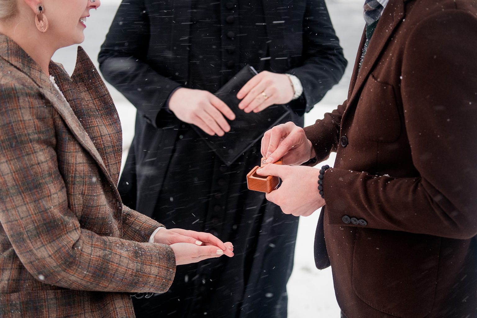 Exchanging rings during an Iceland winter wedding ceremony
