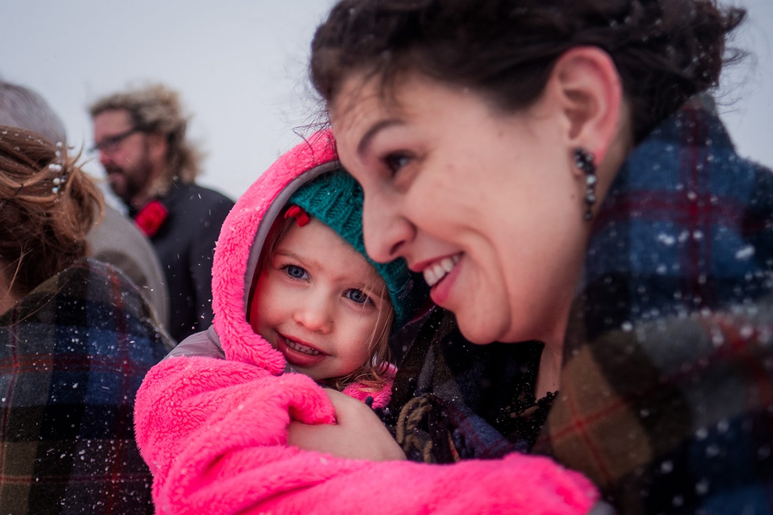Family embracing after the winter wedding ceremony