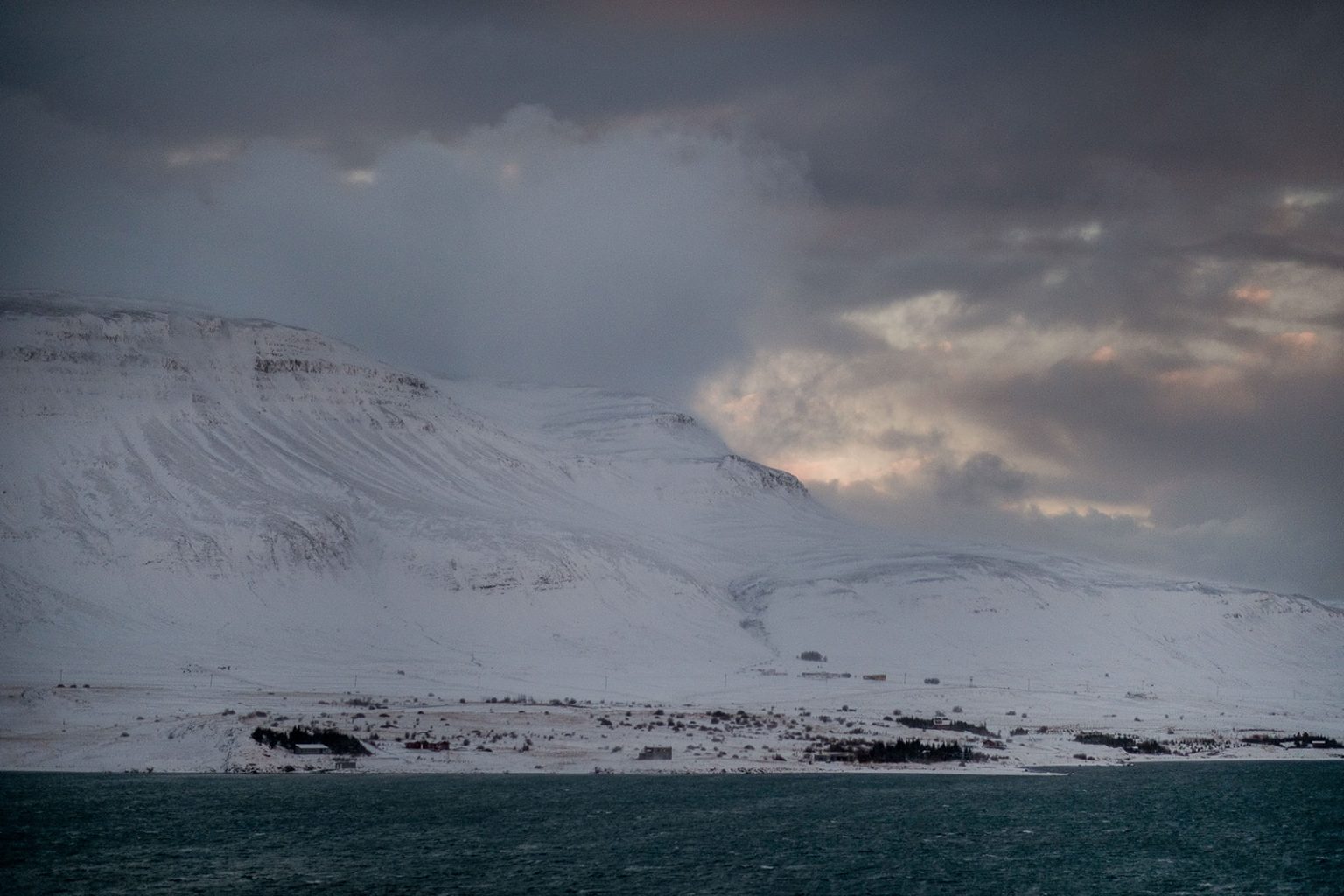 Cloud and snow over the fjord in Hvalfjörður