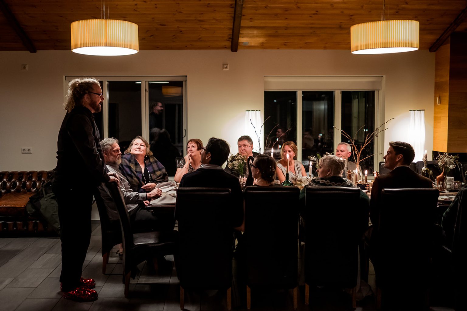 Guests gathered for a candlelit winter wedding dinner