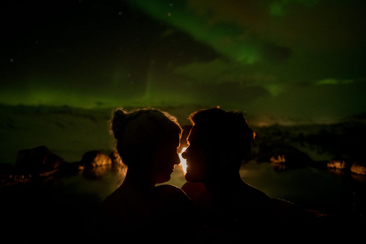 Bride and groom under the northern lights after their Iceland winter wedding