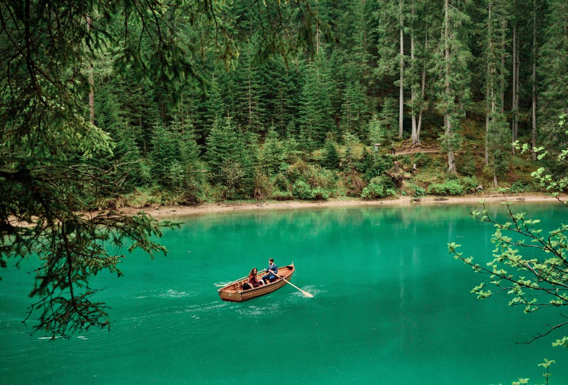 A rowboat on the emerald water of Lago di Braies, elopement in the Dolomites