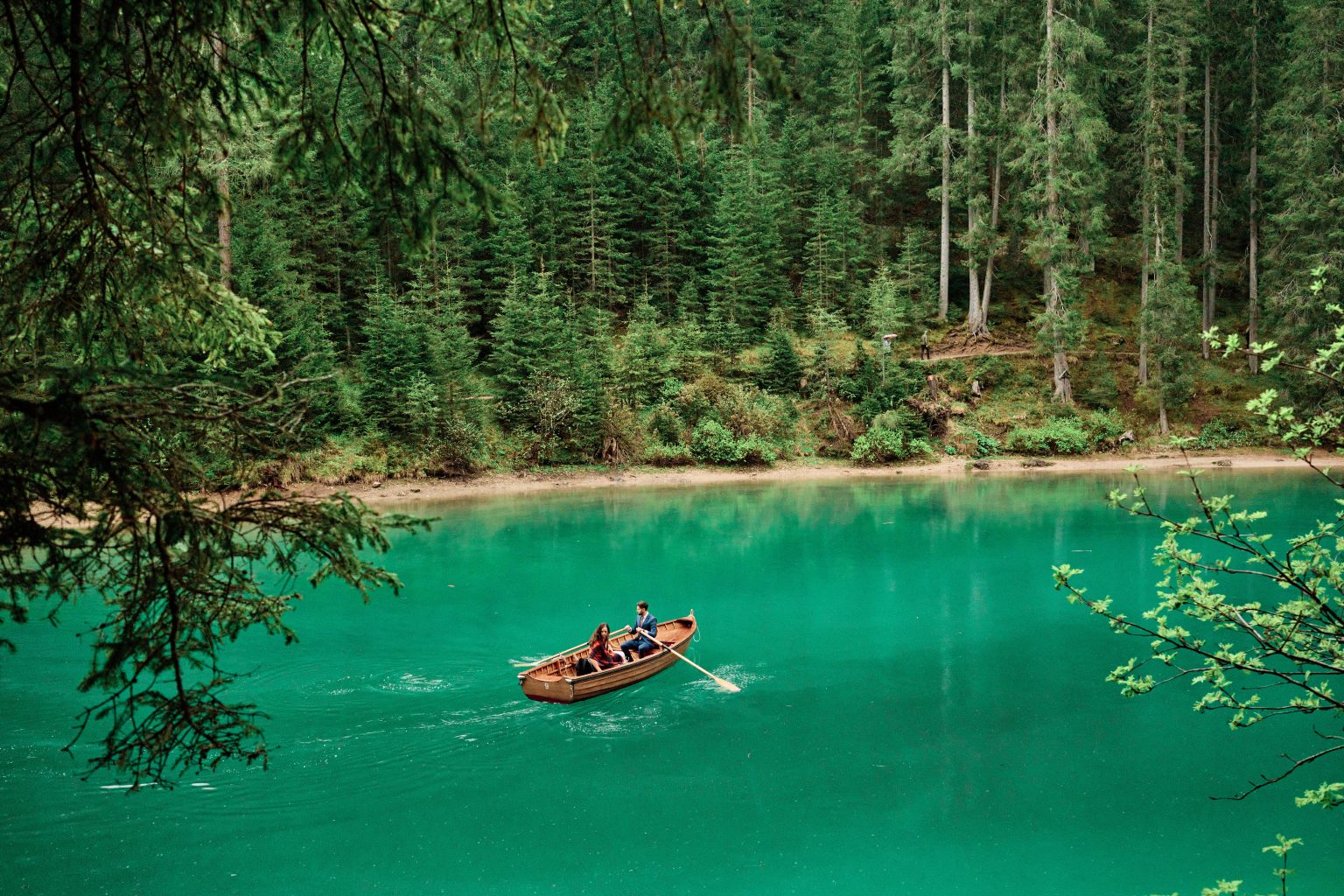 A rowboat on the emerald water of Lago di Braies, elopement in the Dolomites