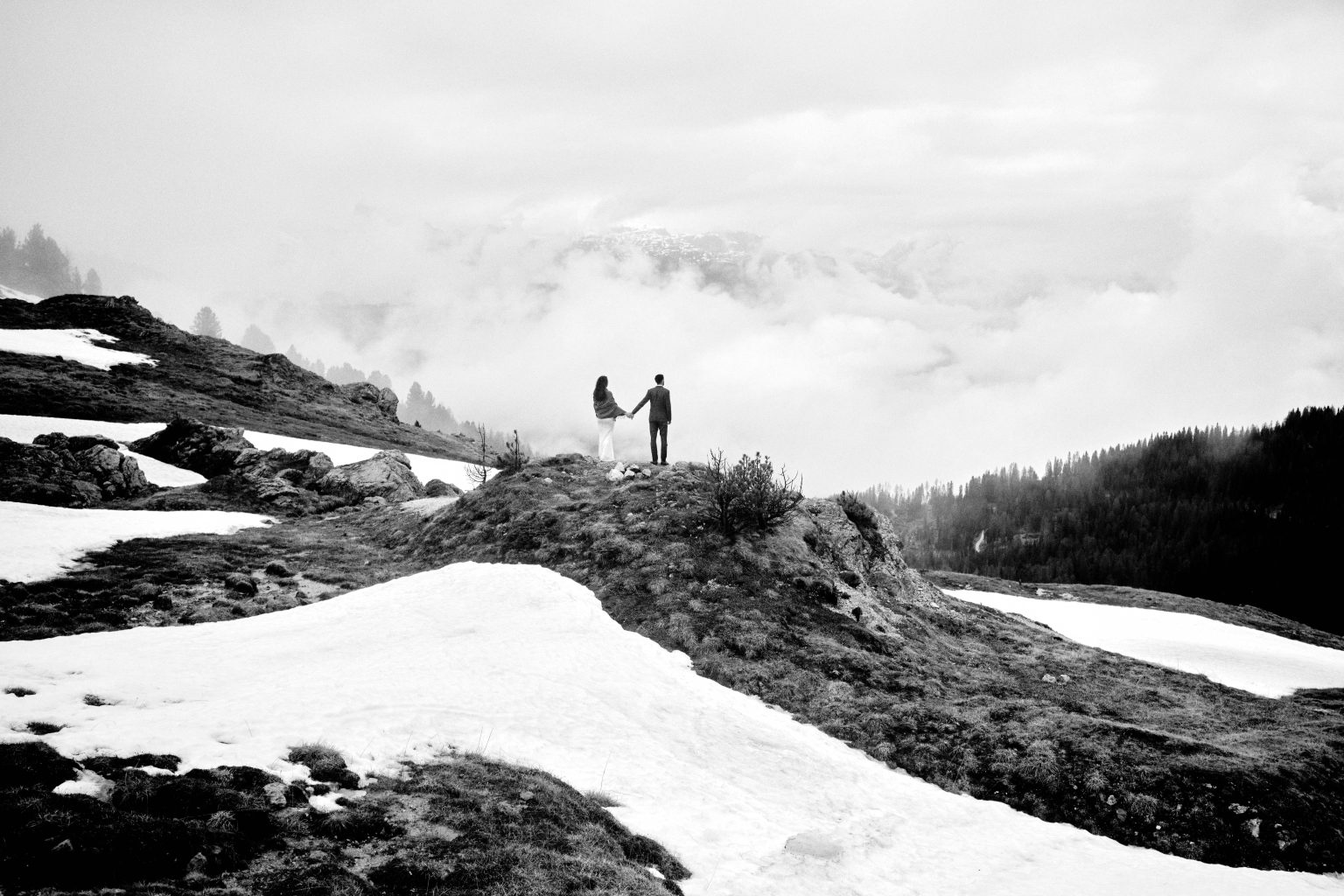 Simona and Marius on a snowy ridge in cloud, Dolomites elopement
