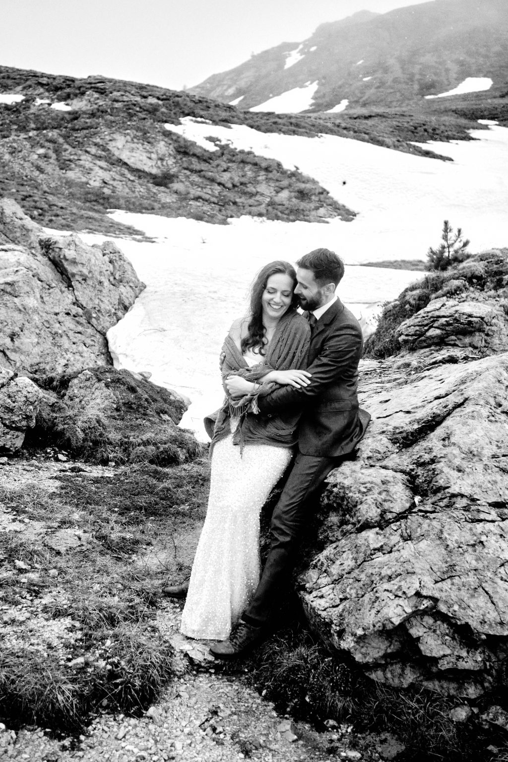 Simona and Marius embracing in the mountains, black and white, Lago di Braies elopement