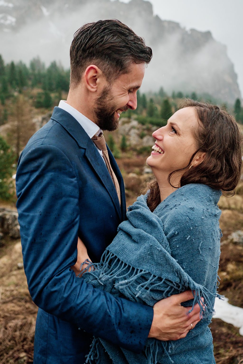 Couple in a downpour at Passo Gardena, Dolomites elopement