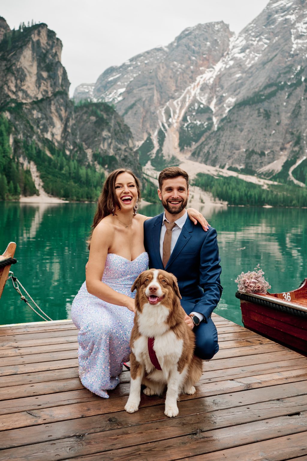 Simona, Marius and their dog Moka in a rowboat, Lago di Braies elopement