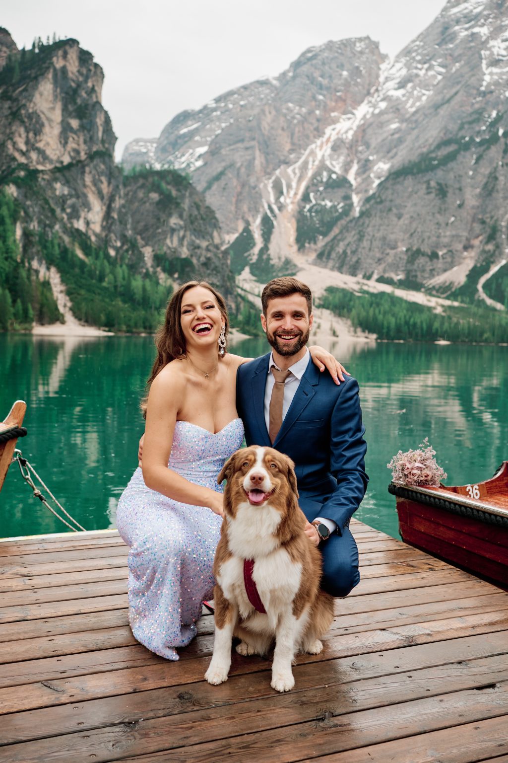 Couple and their Australian shepherd in a boat on Lago di Braies