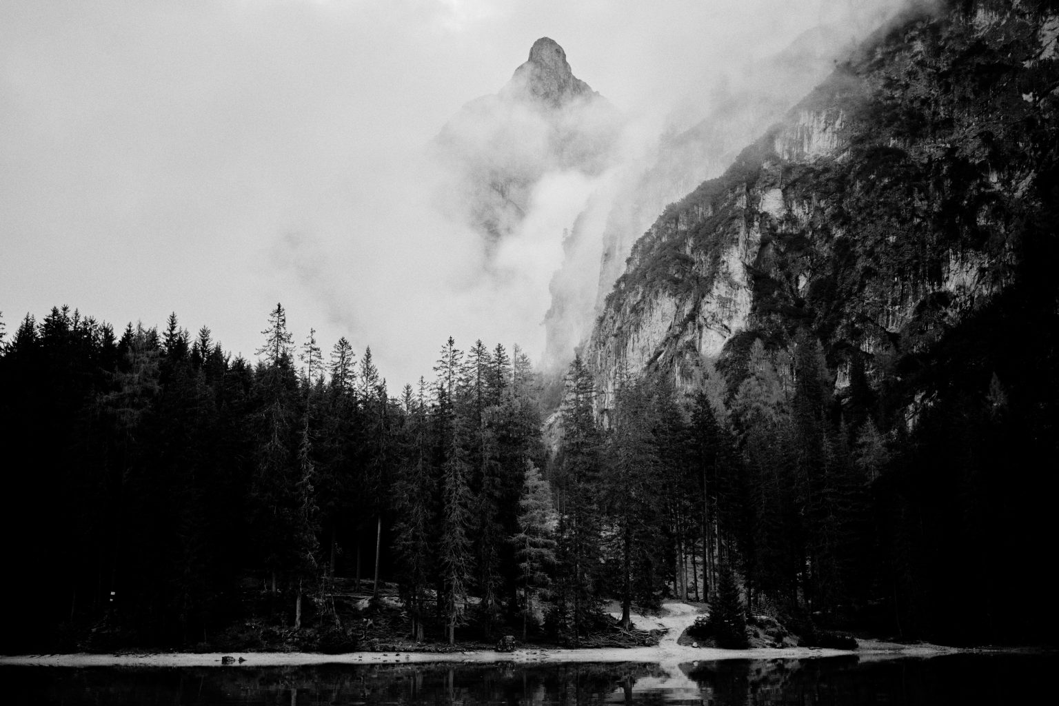 Dark mountains above Lago di Braies, black and white