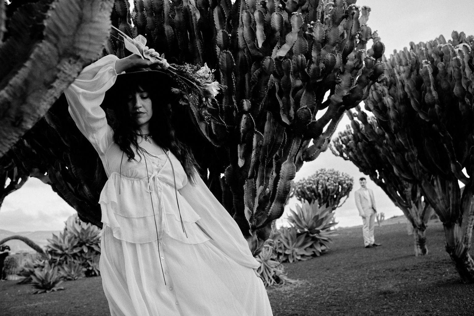 Couple among tall cacti, black and white, Lanzarote
