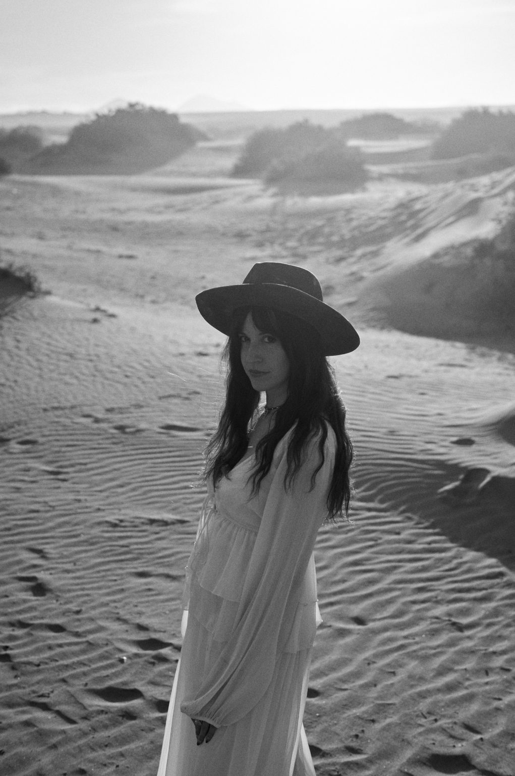 Francesca in her hat in the dunes, black and white, Lanzarote