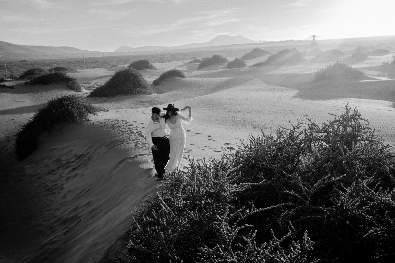 Couple on a dune ridge, black and white, Lanzarote